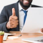 A smiling person with a press release(illustration)